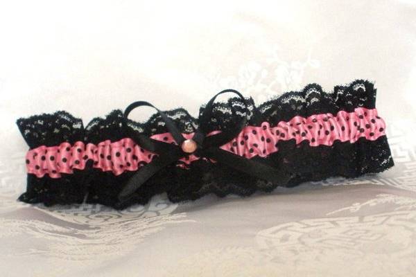 Made with black lace and pink satin ribbon with black polka-dots. It will fit a 15-18 inch leg.
http://www.etsy.com/listing/87119822/garter-black-lace-and-pink-polkadot?ref=v1_other_1