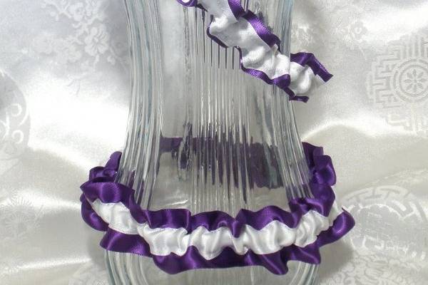 Set of two garters. One garter to toss and the other for a keepsake. Made with purple and white satin ribbon. It will fit a 17-21 inch leg.
http://www.etsy.com/listing/87123528/simple-keep-and-toss-garters-fits-17-21?ref=v1_other_1