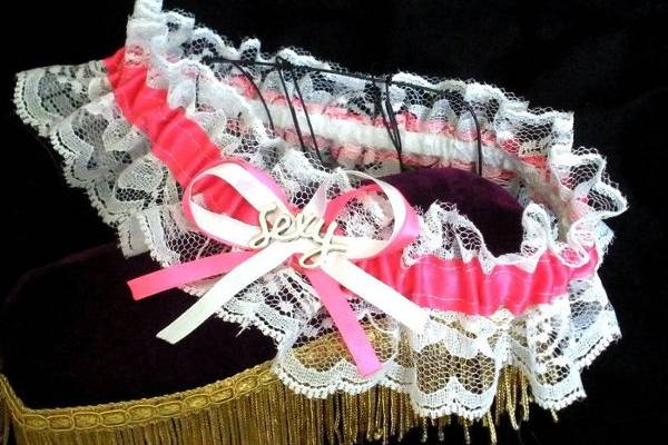 This garter is ready made and will fit a 16-21 inch leg. It's made from pink and white satin ribbon, white lace and a 'sexy' charm.
http://www.etsy.com/listing/86966435/sexy-satin-garter-pink-and-white-satin?ref=v1_other_1