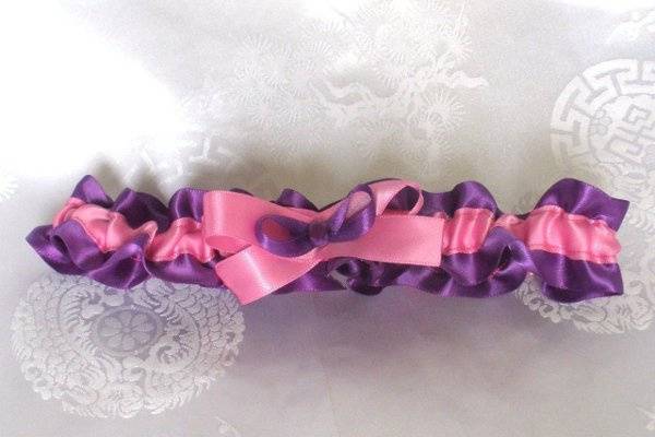 This garter is made with pretty pink and purple satin ribbon. It will fit a 16-20 inch leg.
http://www.etsy.com/listing/87110614/pink-and-purple-satin-ribbon-garter-fits?ref=v1_other_1
