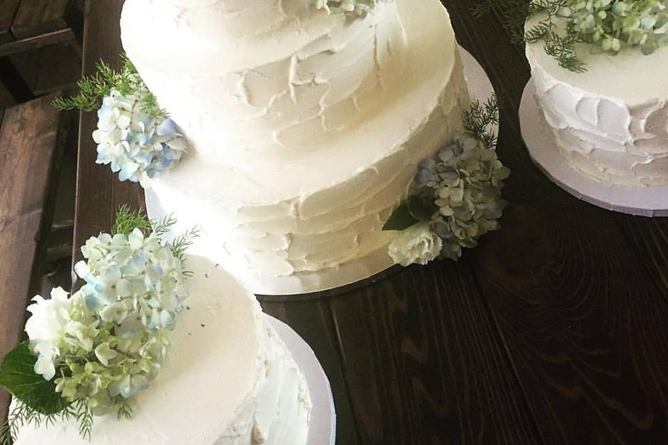 Three white wedding cakes