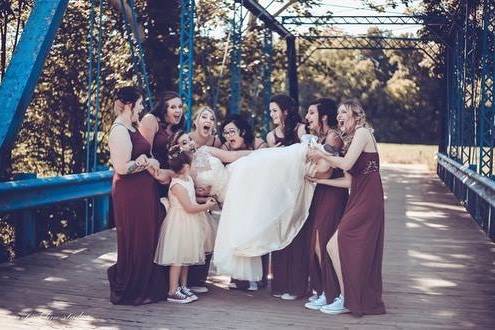 Bridal party lifting the bride