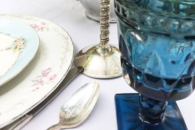 mismatched dinnerware, plates, vintage glasses, silverware and serving dishes