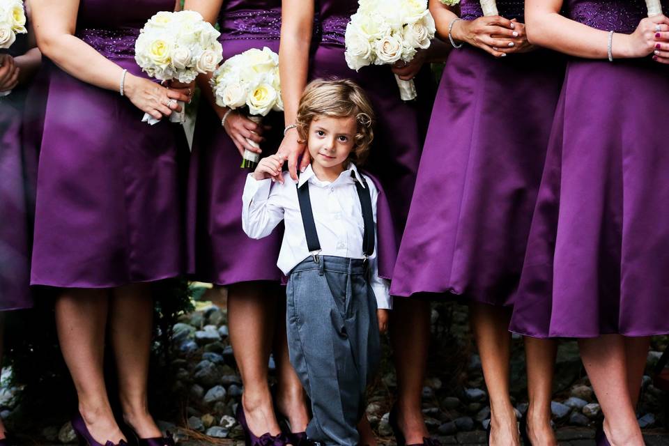 Wedding party posing with cute kid