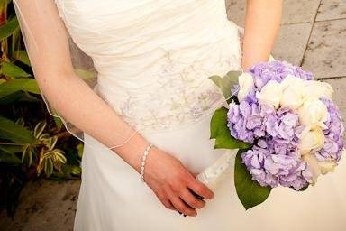 This beautiful bride pauses and reflects for a moment with her bouquet. What a stunning wedding.
