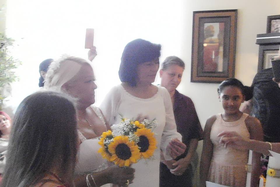 Gloria and Maribel in the center facing the wedding officiant.