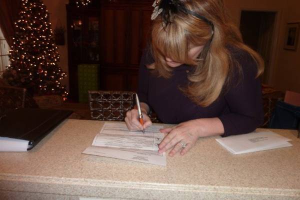 Angie signing their licence.