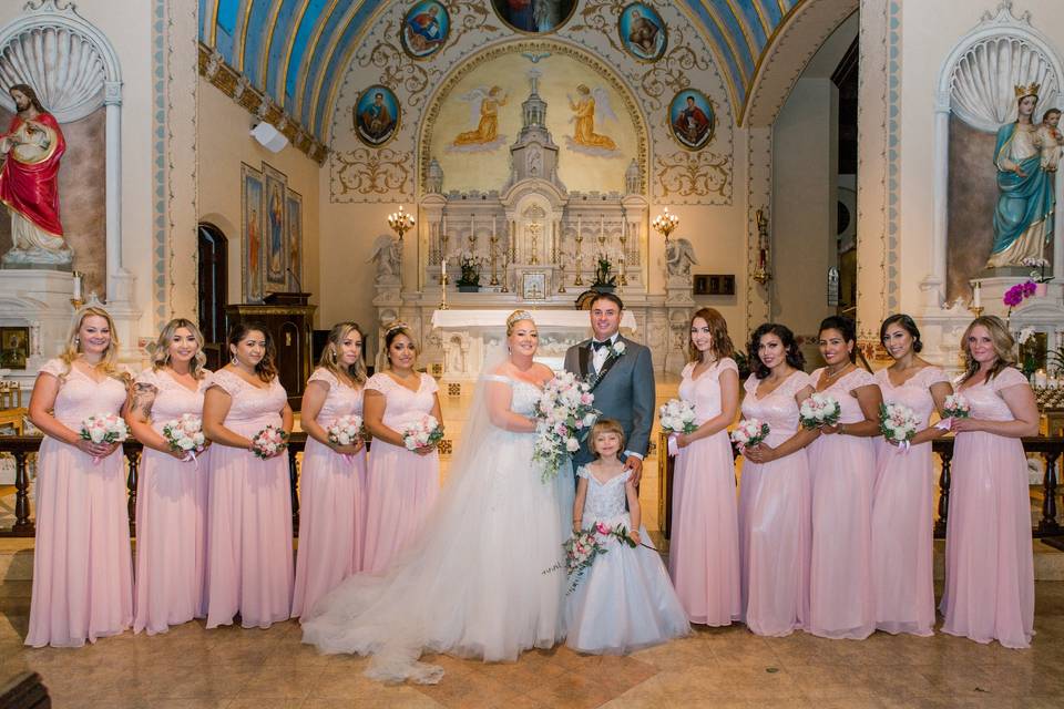 Newlyweds, bridesmaids, and flower girl