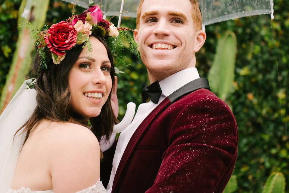 Newlyweds sharing an umbrella