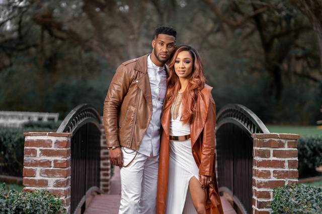 Happy couple pictured in front of a bridge - Breaux Moments Photography