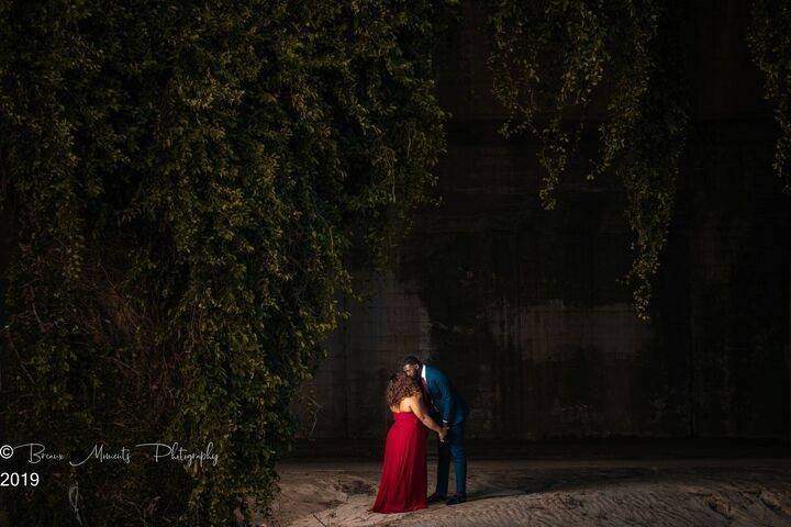 Couple kissing and holding hands - Breaux Moments Photography