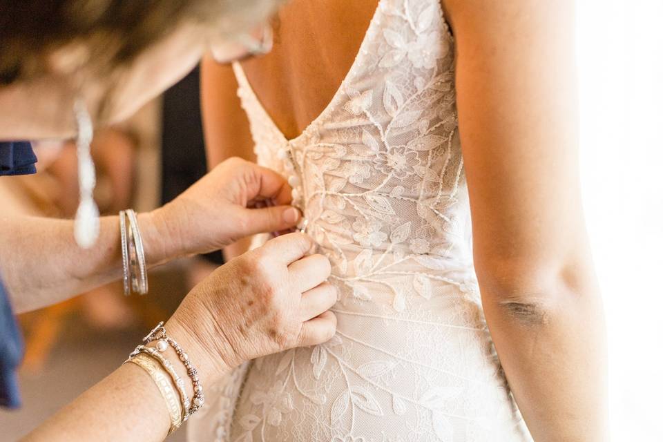 Buttoning up the wedding gown