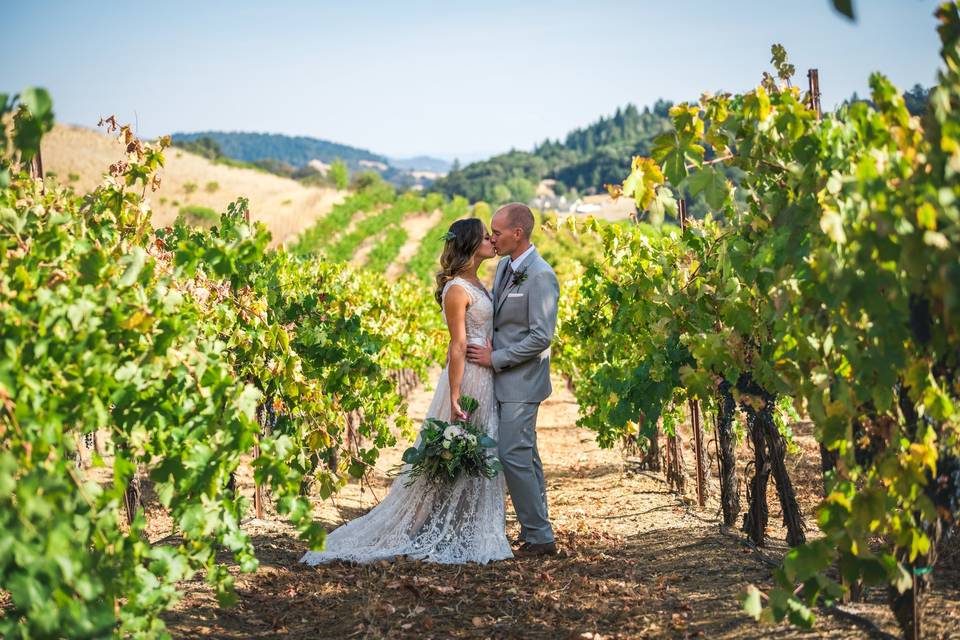 Couple kissing in vineyard