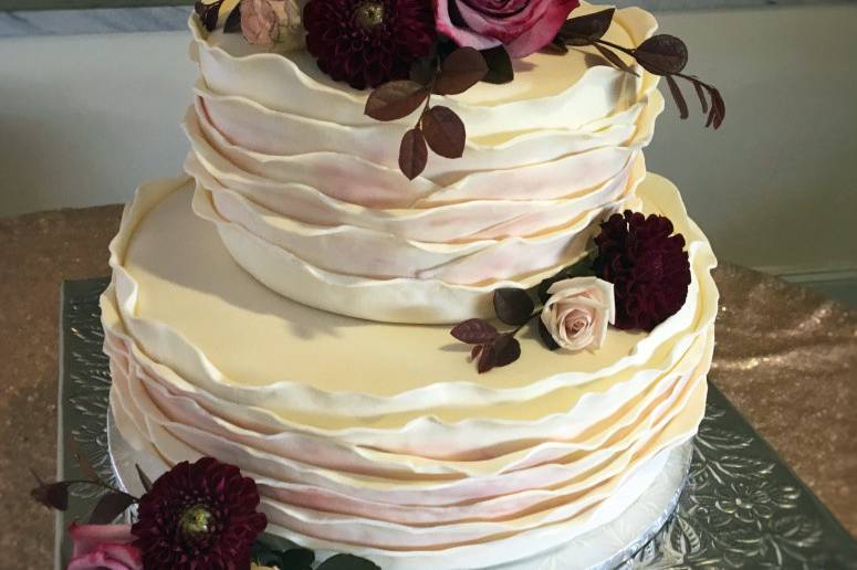 We believe that a cake should look as beautiful sliced as it does unsliced. The cake pictured is lemon cake with a fresh raspberry filling and vanilla Italian meringue buttercream.(Photo credit Shauntul Gull Photography)