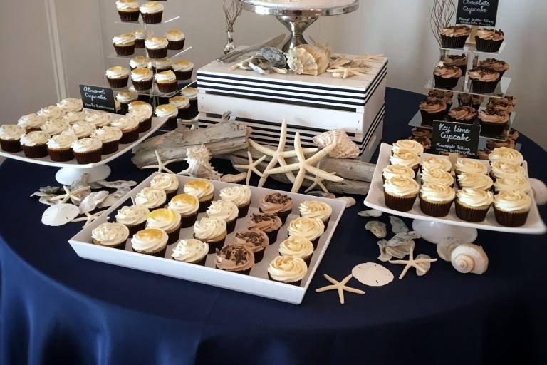 When you cannot decide between a cake or cupcakes - don't choose! A very popular option is to use a cutting cake with cupcakes. This allows for the best of both worlds! (Photo credit Allie Miller Photography)
