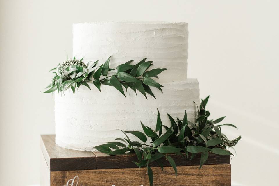 Our house chocolate cake covered in our Italian meringue buttercream featuring a simple and elegant texture, finished with some fresh greens. (Photo credit Segull Photography)