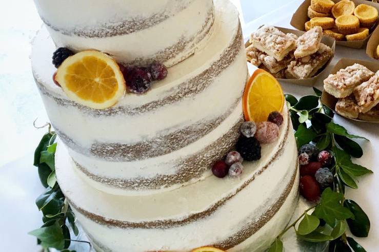 Semi naked spice cake with caramel buttercream - finished with dehydrated oranges, frosted grapes and blackberries.