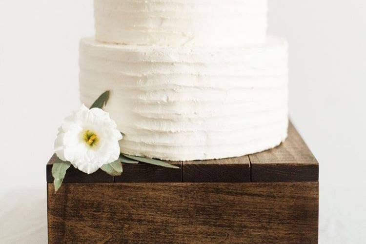 Textured buttercream almond cake placed on a gorgeous cake stand (Photo Credit Shauntell Gull Photography, Cake Stand Sweet Carolina Collective)