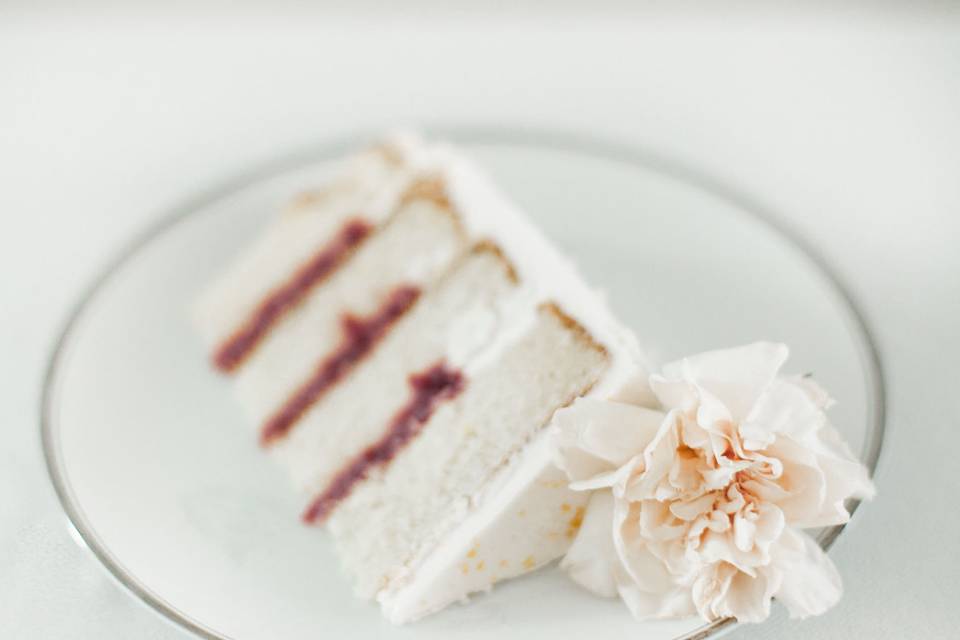 We believe that a cake should look as beautiful sliced as it does unsliced. The cake pictured is lemon cake with a fresh raspberry filling and vanilla Italian meringue buttercream.(Photo credit Shauntul Gull Photography)