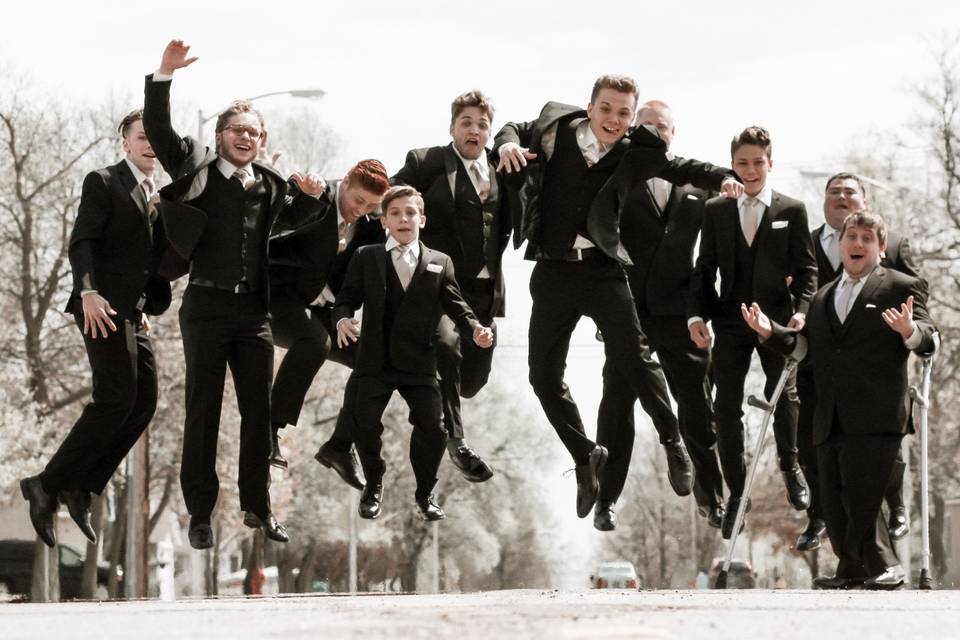 Wedding party jumping for joy