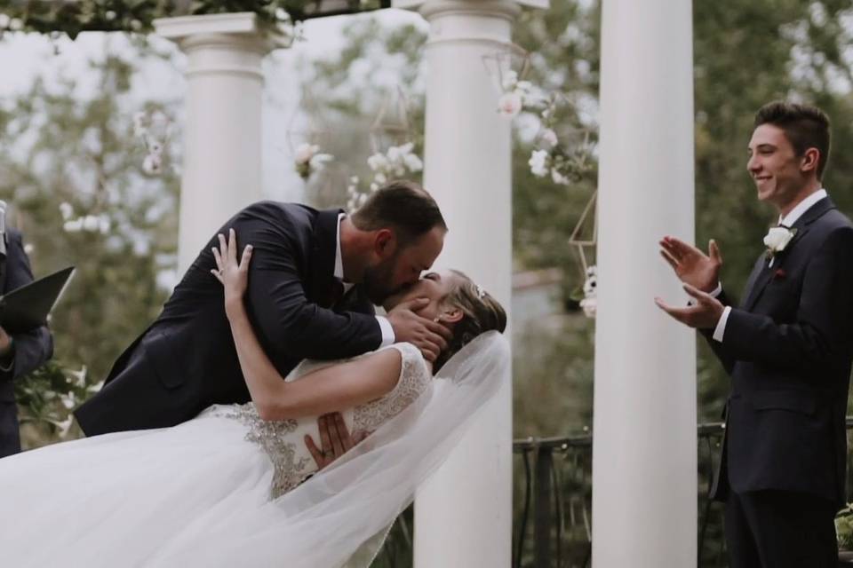 Groom dipping bride