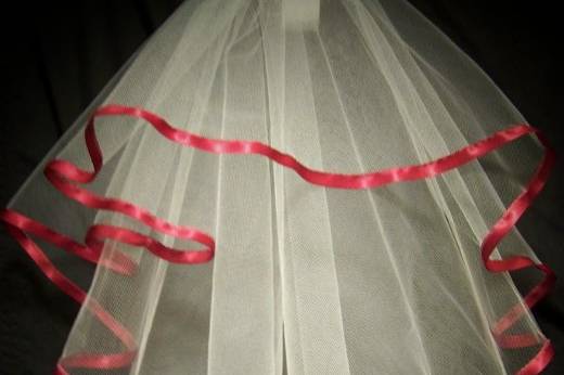 This is a very cute shoulder length, full circle cut veil with white tulle and trimmed with 3/8