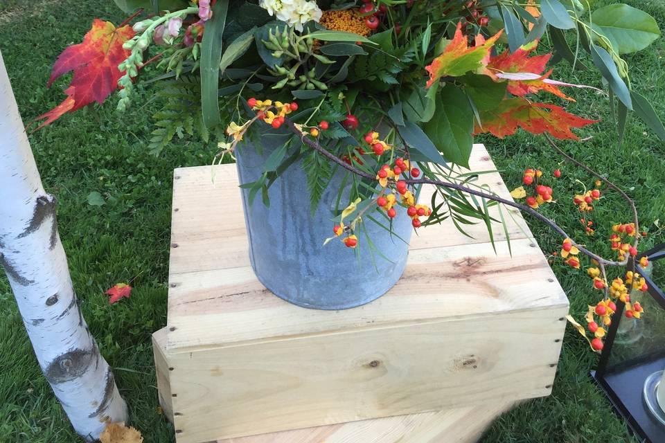 Ceremony arrangement at Trapp Family Lodge featuring fall blooms with greenery & featuring bittersweet!