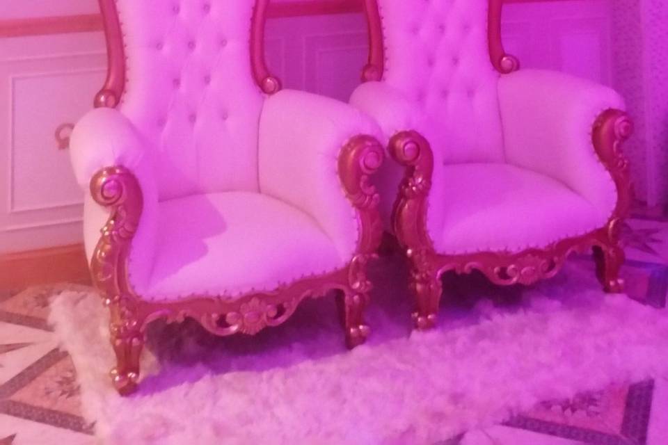 2 throne chairs  with ivory rugs.Ivory and gold.