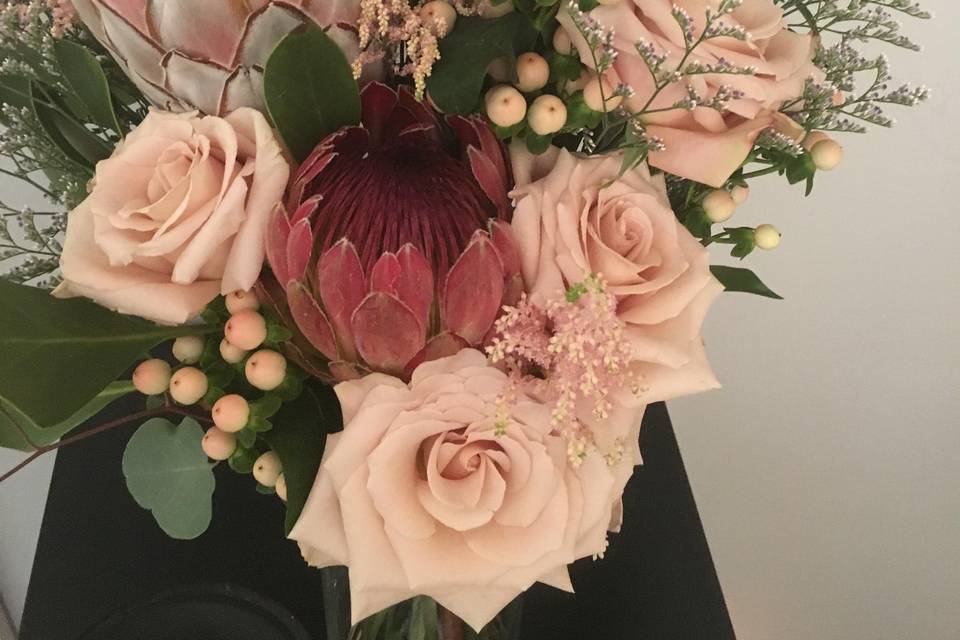 Protea, soft roses, berries