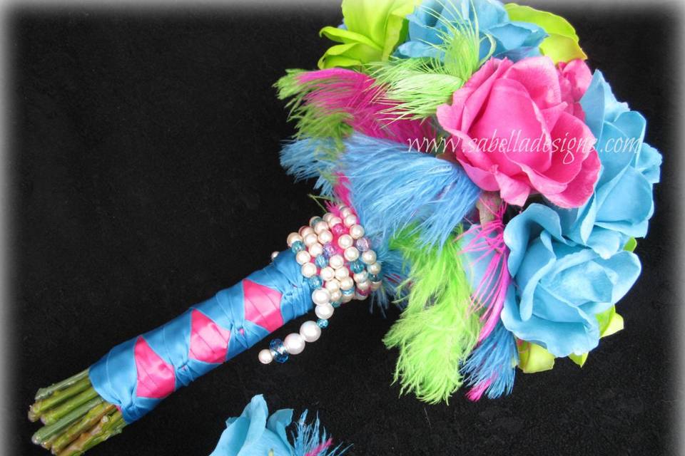 Super fun, funky, unique, and beautiful rainbow inspired bouquet full of vibrant colors! Accented in pearls with feather trim. Matching boutonniere.