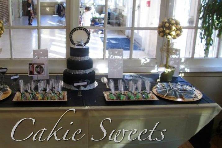 Elegant Sweets table with wedding ring cake. Includes Rocher topiaries, cake pops, and personalized fondant covered sugar cookies.