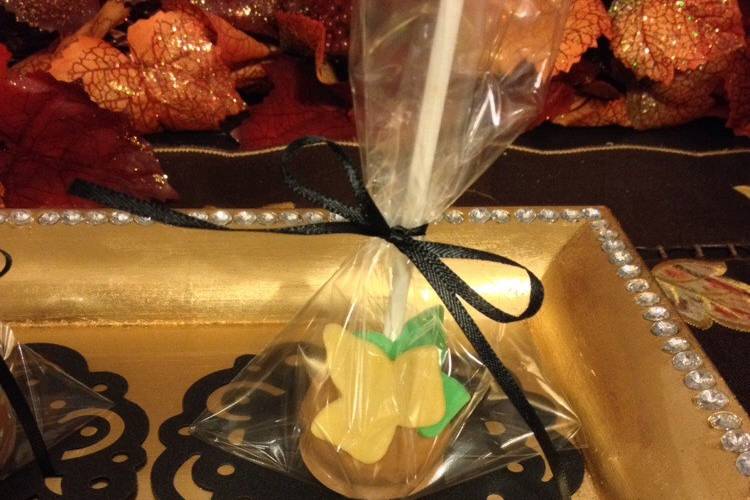 Vanilla Cake pops dipped in slater caramel and adorned with fondant leaves. Individualy wrapped and tied with ribbon. Can be placed on a sweets table and double as a favor.