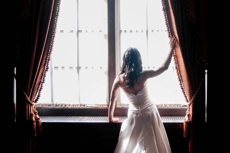 Full length portrait of Asian bride displaying her wedding dress train in front of window at Boston Park Plaza. ©2018 Fort Point Media LLC, All Rights Reserved.