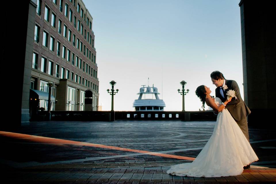 Boston wedding photography of Greek groom and Persian bride under multi-story arch at Boston Harbor Hotel. ©2018 Fort Point Media LLC, All Rights Reserved.