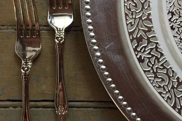 This is our Lace Trim Collection with our Baroque flatware in silver!  Our classic silver charger adds that extra elegant touch for your wedding!  And yes, these are all plastic!  Perfect for the DIY bride or event planner!