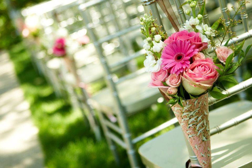 Aisle chair floral accents in the wedding gardens
