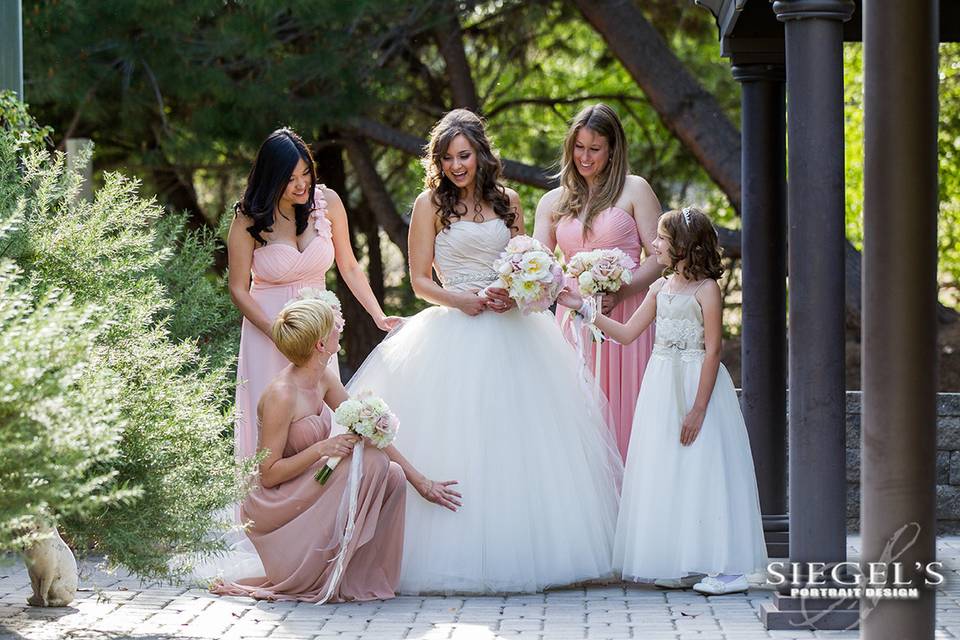 Bride and her bridesmaids in the gardens before the ceremony