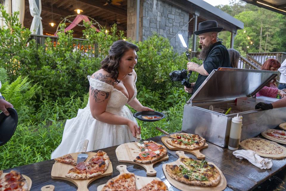 Bride serving pizza