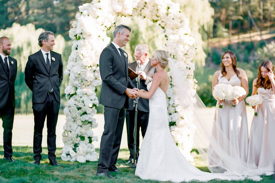 Lavish white wedding arbor