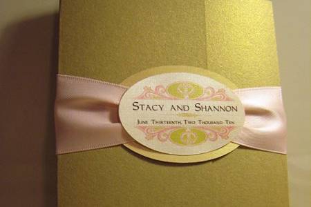 Custom metallic gatefold invitation with pinched satin ribbon belly band and oval seal.