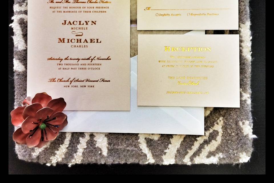 Rose gold foil is letterpressed onto blush pink stock in this classic Central Park Boathouse wedding invitation.
