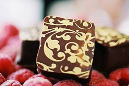 Raspberry Zin: Semi-sweet chocolate ganache with raspberry-zinfandel conserves, dipped in dark chocolate.