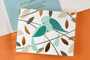Love birds nestle lovingly on this award-winning wedding invitation.