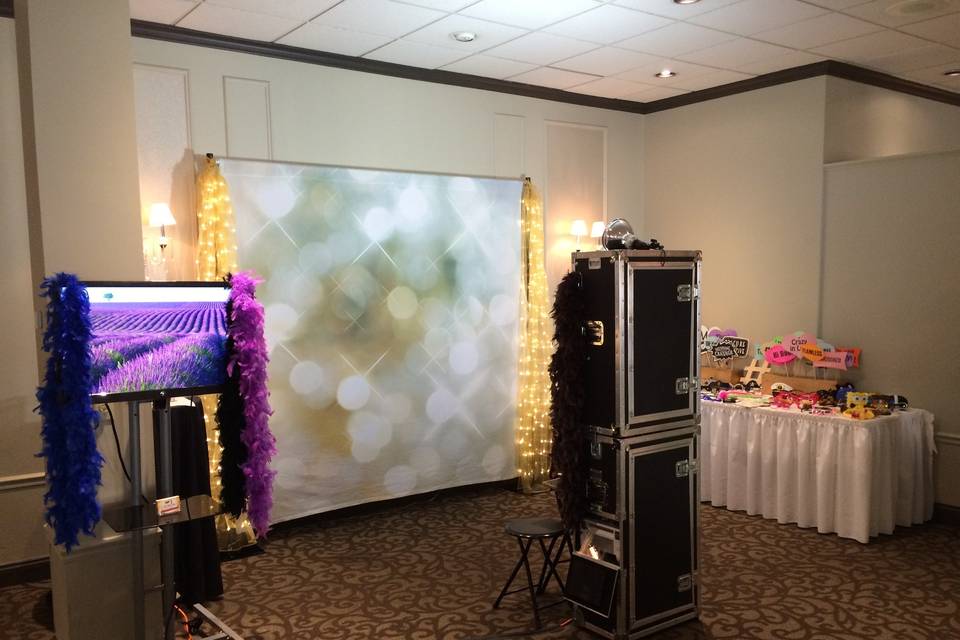 Typical setup: backdrop, 8ft table for all the fun props, monitor to stream all the pictures live as they are taken, and the photo booth. If we are compiling your keepsake wedding album, then we will use a tall round cocktail table.