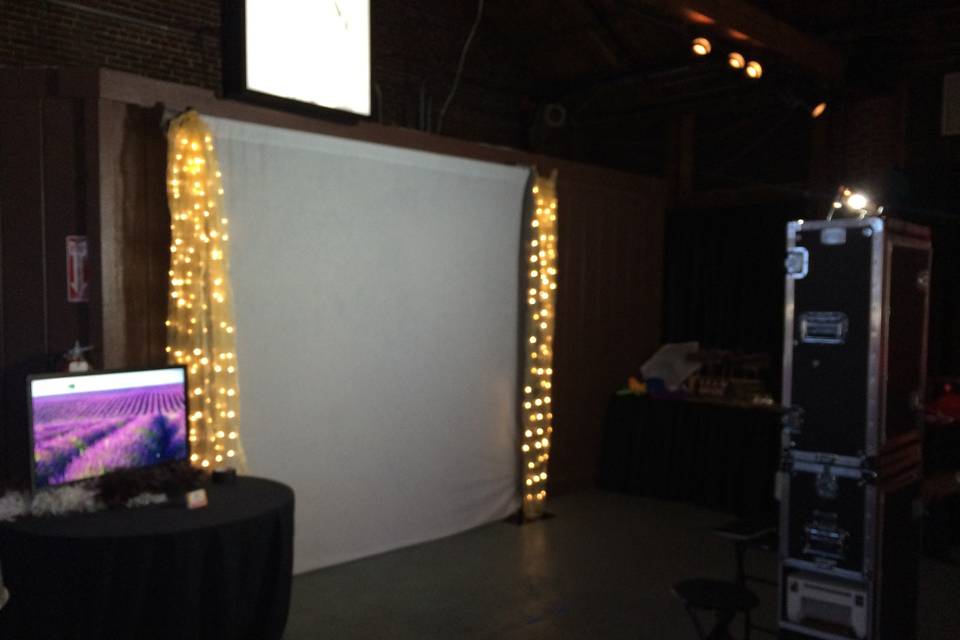 Typical setup: backdrop, 8ft table for all the fun props, monitor to stream all the pictures live as they are taken, and the photo booth. If we are compiling your keepsake wedding album, then we will use a tall round cocktail table.