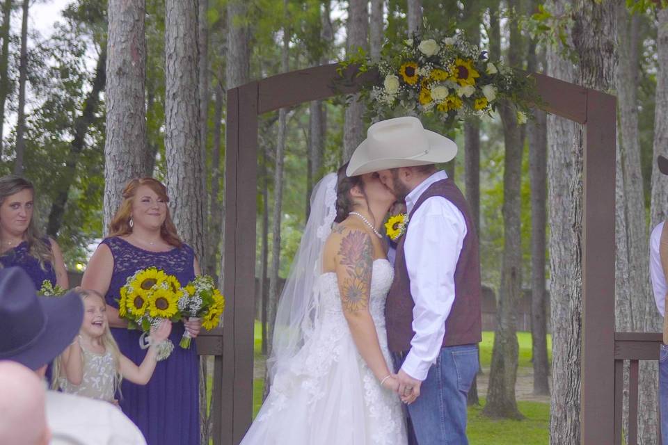 Bride and groom kissing under the altar