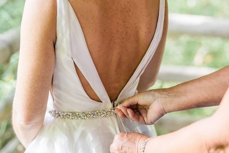 Assisting the bride with her gown