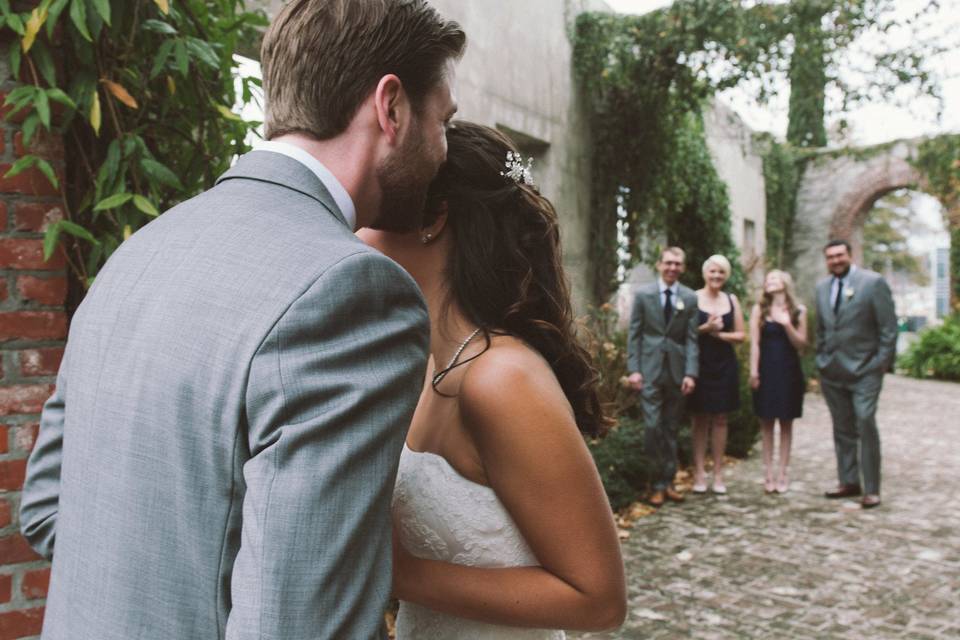 Intimate moment of the Bride & Groom with their bridal party peeking in to show their support & excitement at Summerour Studio in January 2016.