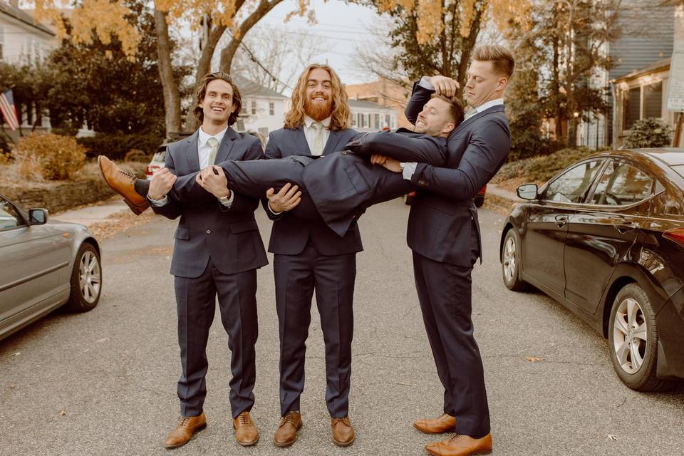 Groomsmen holding groom