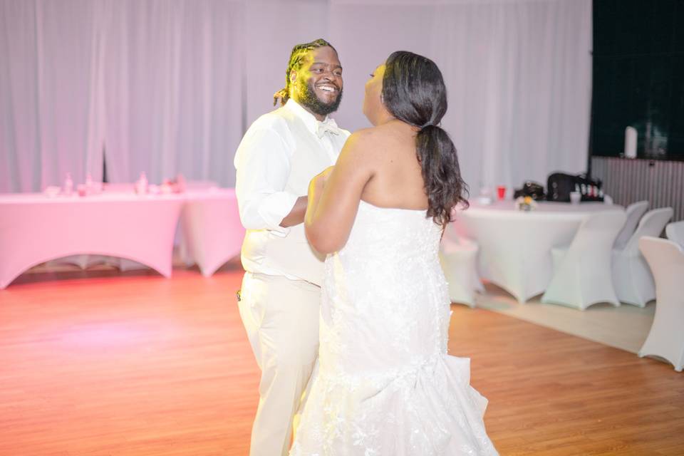 Groom smiles at bride